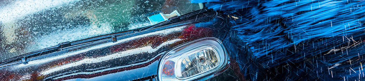 Black crossover going through a Mark VII car wash. 